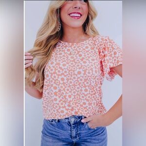 Daisy print, flutter wings, stretchy. Very feminine.